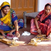 Spinning on her porch in Dariyamau, Suneeta (m) with Rampaytri (l), sister of her mother in law and Meera (r), sister in law